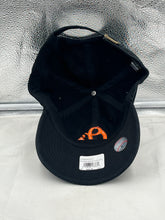 Load image into Gallery viewer, Lifestyle image of a person wearing the Baltimore Orioles MLB '47 Brand Black Clean Up Adjustable Hat outdoors, perfect for game day or casual outings.
