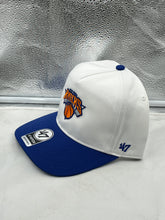 Load image into Gallery viewer, Close-up view of the New York Knicks NBA '47 Brand White Two Tone Hitch Adjustable Snapback Hat showcasing the intricate embroidery of the Knicks logo.