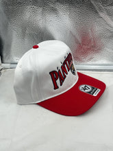 Load image into Gallery viewer, Lifestyle shot of a person wearing Florida Panthers NHL '47 Brand White Two Tone Wave Hitch Adjustable Snapback Hat outdoors, symbolizing team spirit.