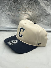Load image into Gallery viewer, Cleveland Guardians MLB '47 Brand Natural TT Hitch Adjustable Snapback Hat displayed on a wooden table, showcasing its adjustable design and premium materials.