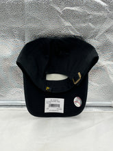 Load image into Gallery viewer, A person wearing the Pittsburgh Pirates MLB '47 Brand Black Clean Up Adjustable Hat while enjoying a baseball game outdoors.