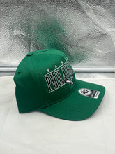 Load image into Gallery viewer, Model wearing the Philadelphia Eagles NFL '47 Brand Throwback Green Hitch Snapback Adjustable Hat at a tailgate party to demonstrate style and support for the Eagles.