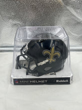 Load image into Gallery viewer, Close-up view of the New Orleans Saints NFL Riddell Speed Black Alternate Replica Mini Helmet showcasing the iconic Saints logo.