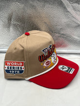 Load image into Gallery viewer, Lifestyle image of the Reds Vs Red Sox 1975 World Series Dueling MLB '47 Khaki Hitch Adjustable Hat worn casually at an outdoor event.