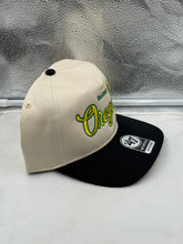 Load image into Gallery viewer, Oregon Ducks '47 Brand Natural TT Hitch Adjustable Snapback Hat featured outdoors, illustrating its sun protection capability and suitability for all seasons.