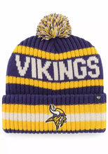 Load image into Gallery viewer, Minnesota Vikings NFL '47 Brand Winter Beanie Knit Ski Cap Hat displayed in a cozy indoor setting, showcasing its stylish design and warm fabric.
