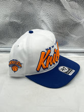 Load image into Gallery viewer, New York Knicks NBA '47 Brand White TT Script Hitch Adjustable Snapback Hat displayed against a vibrant background.