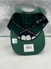 Load image into Gallery viewer, Model wearing the Green Bay Packers NFL '47 Brand Green Script Rope Hitch Snapback Adjustable Hat outdoors, representing team spirit with casual outfit featuring jeans and a t-shirt.