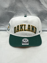 Load image into Gallery viewer, Oakland Athletics MLB '47 Brand White TT Script Hitch Adjustable Snapback Hat displayed on a wooden table.
