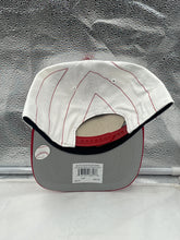 Load image into Gallery viewer, Model wearing the Cincinnati Reds MLB '47 Brand White TT Script Hitch Adjustable Snapback Hat at a baseball game, demonstrating its adjustable fit and comfort.