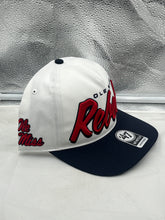 Load image into Gallery viewer, Model wearing the Ole Miss Rebels NCAA '47 Brand White Script Hitch Adjustable Snapback Hat, displaying its adjustable fit and trendy aesthetic.