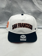 Load image into Gallery viewer, San Francisco Giants MLB '47 Brand White TT Script Hitch Adjustable Snapback Hat displayed on a wooden table, highlighting its stylish design and bold script.