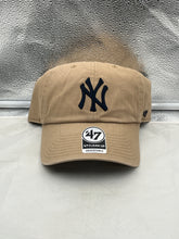 Load image into Gallery viewer, New York Yankees MLB '47 Brand Khaki Clean Up Adjustable Strapback Hat displayed on a mannequin head, showcasing its relaxed fit and iconic Yankees logo.