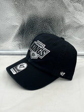Load image into Gallery viewer, Side view of Los Angeles Kings NHL '47 Brand Clean Up Black Adjustable Hat displaying the adjustable strap for a customized fit.