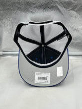 Load image into Gallery viewer, A fan wearing the St Louis Blues NHL '47 Brand Throwback Blue Trucker Adjustable Snapback Hat, showcasing team spirit at a hockey game.