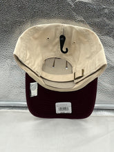 Load image into Gallery viewer, Vancouver Canucks NHL '47 Brand Throwback Clean Up Tan Two Tone Adjustable Hat displayed on a flat surface, showcasing its stylish design and team logo.