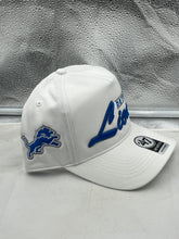 Load image into Gallery viewer, Detroit Lions NFL '47 Brand White Script Hitch Snapback Adjustable Hat displayed on a wooden background, showcasing the elegant script design and team logo.