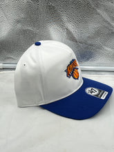 Load image into Gallery viewer, New York Knicks NBA '47 Brand White Two Tone Hitch Adjustable Snapback Hat worn by a fan at a basketball game, displaying team spirit and style.