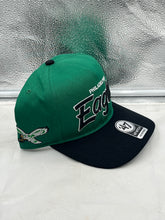 Load image into Gallery viewer, Lifestyle image of a person wearing the Philadelphia Eagles NFL '47 Throwback Green Script Hitch Snapback Adjustable Hat at a tailgate party.