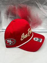 Load image into Gallery viewer, San Francisco 49ers NFL '47 Brand Red Script Hitch Rope Snapback Adjustable Hat worn by a fan at a game, highlighting team spirit.