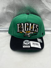 Load image into Gallery viewer, Philadelphia Eagles NFL '47 Throwback Green TT Hitch Snapback Adjustable Hat displayed on a wooden surface showcasing its vibrant green color and classic throwback design.