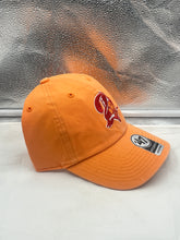 Load image into Gallery viewer, Person wearing the Tampa Bay Buccaneers NFL '47 Brand Throwback Orange Clean Up Adjustable Hat while cheering at a football game, representing team spirit.