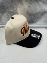 Load image into Gallery viewer, Miami Hurricanes '47 Brand Natural TT Hitch Adjustable Snapback Hat worn by a fan, perfect for game days and casual outings.