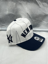 Load image into Gallery viewer, Lifestyle shot of a person wearing the New York Yankees MLB '47 Brand White Pinstripe Hitch Snapback Adjustable Hat, emphasizing its versatility and team spirit.