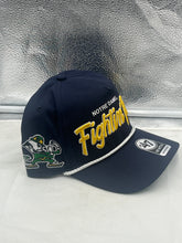 Load image into Gallery viewer, Notre Dame Fighting Irish NCAA '47 Brand Navy Rope Script Hitch Adjustable Hat worn by a fan at a game, demonstrating team pride and perfect fit.