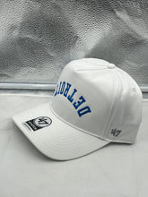 Load image into Gallery viewer, Detroit Lions NFL '47 Brand White Reversed Script Hitch Snapback Adjustable Hat displayed on a table, showcasing its stylish design and bold logo.