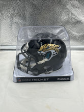 Load image into Gallery viewer, Close-up view of the Jacksonville Jaguars NFL Riddell Speed Black Replica Mini Helmet, highlighting its detailed design and durable construction, perfect for display.
