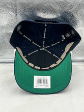 Load image into Gallery viewer, Model wearing the Notre Dame Fighting Irish NCAA '47 Navy Script Hitch Adjustable Snapback Hat at a game, promoting team spirit and style.