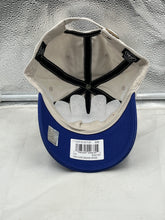 Load image into Gallery viewer, Lifestyle image of a person wearing the Vancouver Canucks NHL '47 Brand Throwback Clean Up Tan Two Tone Adjustable Hat at a game, showcasing team pride.