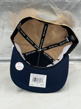 Load image into Gallery viewer, Group image of fans wearing Yankees Vs Padres 1998 World Series Dueling MLB '47 Khaki Hitch Adjustable Hats at a baseball event.