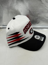 Load image into Gallery viewer, Georgia Bulldogs NCAA '47 Brand White TT Diamond Hitch Snapback Adjustable Hat displayed on a table, showcasing the stylish design and iconic team logo for fans.