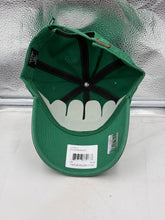 Load image into Gallery viewer, Lifestyle shot of a person wearing the Hartford Whalers NHL '47 Brand Throwback Green Clean Up Adjustable Hat outdoors.