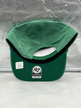 Load image into Gallery viewer, a green hat sitting on top of a white counter