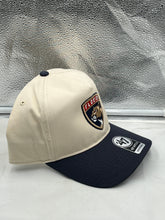 Load image into Gallery viewer, a hat sitting on top of a counter next to a window