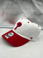 Load image into Gallery viewer, a red and white hat sitting on top of a window sill