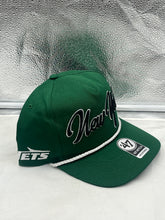 Load image into Gallery viewer, New York Jets NFL '47 Green Rope Script Hitch Snapback Adjustable Hat worn by a fan at a game, emphasizing team spirit and casual style.