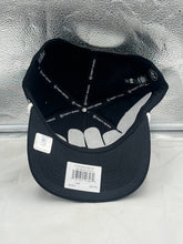 Load image into Gallery viewer, Wearing the Baltimore Ravens hat with a casual outfit, demonstrating how to style this fan gear with jeans and a t-shirt.