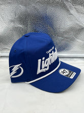 Load image into Gallery viewer, Display of the Tampa Bay Lightning NHL '47 Blue Script Hitch Rope Adjustable Snapback Hat highlighting its quality material and fashionable design.