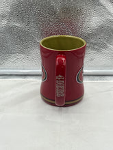 Load image into Gallery viewer, Close-up view of the San Francisco 49ers NFL Logo Brands 14oz Mug Cup, showcasing its durable ceramic material and stylish design for everyday use.