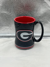 Load image into Gallery viewer, a black and red mug sitting on top of a window sill