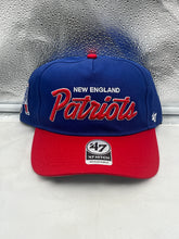 Load image into Gallery viewer, New England Patriots NFL '47 Throwback Blue Script Hitch Snapback Adjustable Hat displayed on a wooden surface showcasing its vintage design and vibrant blue color.