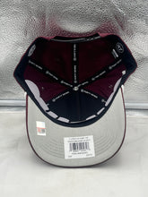 Load image into Gallery viewer, Person wearing Texas A&M Aggies NCAA '47 Brand Maroon Script Hitch Rope Adjustable Snapback Hat outdoors, demonstrating its comfort and adjustable fit in a casual setting.