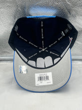Load image into Gallery viewer, Person wearing the Tennessee Titans NFL '47 Blue Two Tone Script Hitch Snapback Adjustable Hat outdoors, demonstrating its adjustable fit and modern design.