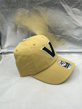 Load image into Gallery viewer, Vanderbilt Commodores NCAA &#39;47 Brand Gold Clean Up Adjustable Strapback Hat worn by a fan at a game, demonstrating team pride and all-day comfort.
