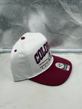 Load image into Gallery viewer, Colorado Avalanche NHL '47 White Two Tone Roscoe Hitch Adjustable Snapback Hat staked in outdoor setting, ideal for showing team pride while enjoying games.

