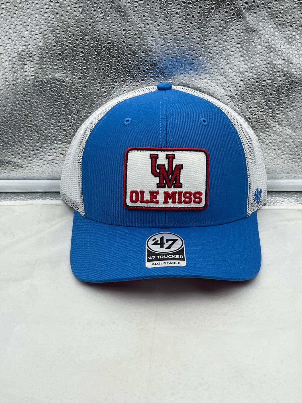 Ole Miss Rebels NCAA '47 Brand Blue Trucker Mesh Adjustable Snapback Hat showcasing vibrant blue color and team emblem.